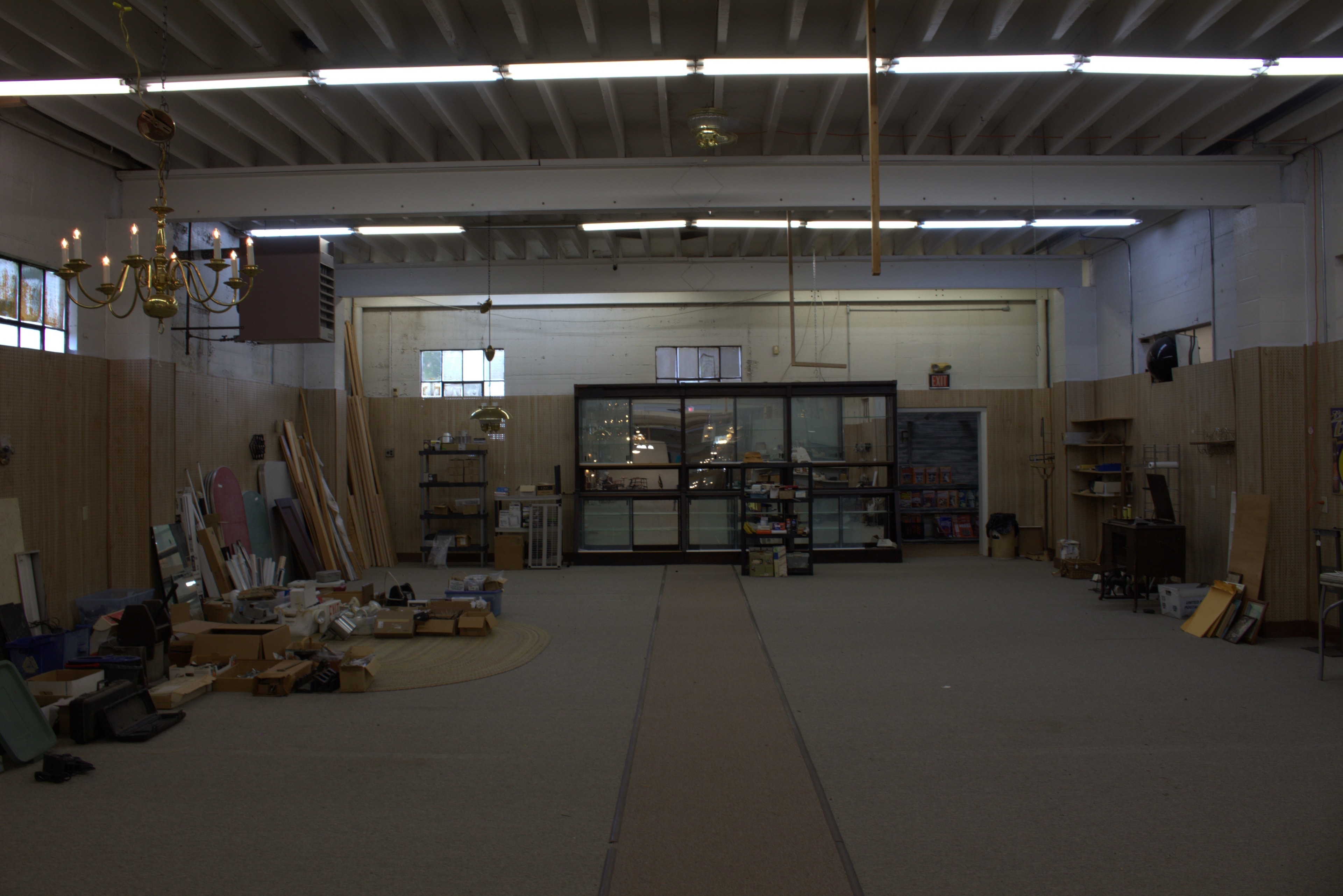 Rear Wall — Glass Storefront & Brass Chandelier